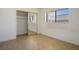 Bedroom with tile flooring, large window, and closet with mirrored doors at 4911 W Pebble Rd, Las Vegas, NV 89139