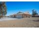 Single story home with an attached two car garage surrounded by desert landscape at 4911 W Pebble Rd, Las Vegas, NV 89139