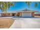 Single story home with a large driveway and a two car garage surrounded by desert style landscaping at 4911 W Pebble Rd, Las Vegas, NV 89139