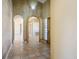 Tiled foyer with decorative arches and a chandelier provides access to the home at 4911 W Pebble Rd, Las Vegas, NV 89139