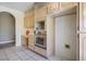 Well-equipped kitchen showcasing built-in stainless steel oven, light wood cabinets, and desk area at 4911 W Pebble Rd, Las Vegas, NV 89139