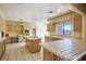 Bright kitchen featuring light wood cabinetry, an island cooktop, and tiled countertops for a functional space at 4911 W Pebble Rd, Las Vegas, NV 89139