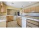 Functional kitchen space featuring tiled countertops, wooden cabinets, and white appliances for meal preparation at 4911 W Pebble Rd, Las Vegas, NV 89139