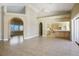 Open-concept living room showcasing tile floors, neutral walls, and seamless flow to the kitchen for modern living at 4911 W Pebble Rd, Las Vegas, NV 89139