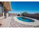 An in-ground pool with colorful brick trim and an adjacent patio area, all enclosed by a brick wall fence at 4911 W Pebble Rd, Las Vegas, NV 89139