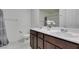 Bathroom with double sinks, a linen closet, and a shower tub combo at 5382 El Nevero St, Las Vegas, NV 89166