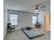 Bright bedroom featuring two windows, ceiling fan, and neutral carpet at 5382 El Nevero St, Las Vegas, NV 89166