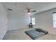 Spacious bedroom featuring neutral carpet, two windows and ceiling fan at 5382 El Nevero St, Las Vegas, NV 89166