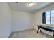 Bright bedroom featuring neutral carpet, a window and a modern light fixture at 5382 El Nevero St, Las Vegas, NV 89166