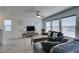 Cozy living room with a ceiling fan and large windows that provide natural light at 5382 El Nevero St, Las Vegas, NV 89166