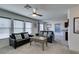 Bright living room featuring neutral walls, plush seating, and a ceiling fan at 5382 El Nevero St, Las Vegas, NV 89166