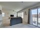 Bright living room showcasing large windows, a ceiling fan, and neutral decor at 5382 El Nevero St, Las Vegas, NV 89166