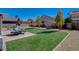 Backyard area with artificial turf, desert landscaping, and privacy at 5827 Delonee Skies Ave, Las Vegas, NV 89131