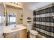 Well-lit bathroom with a single sink vanity and a shower-tub combination at 5827 Delonee Skies Ave, Las Vegas, NV 89131