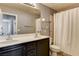 Bathroom features a double sink vanity, toilet, shower and views into other rooms at 5827 Delonee Skies Ave, Las Vegas, NV 89131