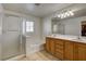 Well-lit primary bathroom with a double sink vanity and a separate shower stall at 5827 Delonee Skies Ave, Las Vegas, NV 89131