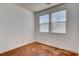 A bright bedroom with two windows, a closet, neutral walls, and stained concrete flooring at 5827 Delonee Skies Ave, Las Vegas, NV 89131