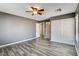 Bedroom featuring a ceiling fan, wood-look floors, closet and an ensuite bathroom at 5827 Delonee Skies Ave, Las Vegas, NV 89131