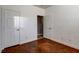 A bright bedroom with two doors, a closet, neutral walls, and stained concrete flooring at 5827 Delonee Skies Ave, Las Vegas, NV 89131