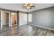 Bedroom featuring a ceiling fan, wood-look floors, closet and an ensuite bathroom at 5827 Delonee Skies Ave, Las Vegas, NV 89131