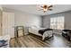 Bedroom features a ceiling fan, wood-look floors, a window and a large bed at 5827 Delonee Skies Ave, Las Vegas, NV 89131