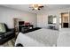 Bedroom showcasing a bed, wood-look flooring, ceiling fan, desk, and closet space at 5827 Delonee Skies Ave, Las Vegas, NV 89131