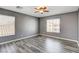 Spacious bedroom featuring wood-look floors, neutral paint, and lots of natural light at 5827 Delonee Skies Ave, Las Vegas, NV 89131