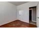 A bright bedroom with two doors, a closet, neutral walls, and stained concrete flooring at 5827 Delonee Skies Ave, Las Vegas, NV 89131