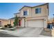 Charming two-story home with a red front door, desert landscaping, and an attached two-car garage at 5827 Delonee Skies Ave, Las Vegas, NV 89131