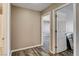 Hallway with hardwood-style flooring and neutral-colored walls, leading to various rooms at 5827 Delonee Skies Ave, Las Vegas, NV 89131