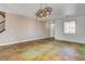 Large living room with decorative light fixture and unique flooring at 5827 Delonee Skies Ave, Las Vegas, NV 89131