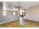 Spacious open-concept living room with a modern chandelier and a staircase at 5827 Delonee Skies Ave, Las Vegas, NV 89131