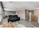 This spacious living room offers ample light from large windows and stylish wood floors at 5827 Delonee Skies Ave, Las Vegas, NV 89131