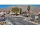 Neighborhood street view with lush landscaping and mountain backdrop at 5827 Delonee Skies Ave, Las Vegas, NV 89131