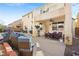 Exterior backyard view featuring a covered patio, pool, and adjacent home at 5832 Ivy Vine Ct, Las Vegas, NV 89141