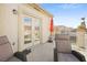 Inviting balcony with chairs, an umbrella and views of the neighborhood, great for outdoor relaxation at 5832 Ivy Vine Ct, Las Vegas, NV 89141