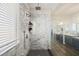 Bathroom featuring a marble shower with glass doors, modern fixtures, and stylish vanities for a spa-like experience at 5832 Ivy Vine Ct, Las Vegas, NV 89141