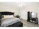 Bedroom featuring neutral walls, grey wood floors, bench, and black furniture at 5832 Ivy Vine Ct, Las Vegas, NV 89141