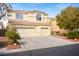 Two-story house with three-car garage, tile roof, and desert landscaping at 5832 Ivy Vine Ct, Las Vegas, NV 89141