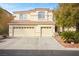 Two-story house with three-car garage, tile roof, and desert landscaping at 5832 Ivy Vine Ct, Las Vegas, NV 89141