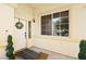 Covered front porch with white door, wreath, and manicured bushes at 5832 Ivy Vine Ct, Las Vegas, NV 89141