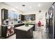 Stylish kitchen showcasing dark cabinets, granite countertops, and a center island at 5832 Ivy Vine Ct, Las Vegas, NV 89141