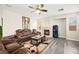 Relaxing living room with a fireplace, ceiling fan, neutral colors, and plenty of seating at 5832 Ivy Vine Ct, Las Vegas, NV 89141