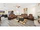 Open-concept living room flows into the kitchen with a cozy fireplace and comfortable seating at 5832 Ivy Vine Ct, Las Vegas, NV 89141