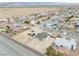 Expansive aerial view showcases the new home in a desert community, complete with construction equipment and mountain views at 6360 Montclair St, Pahrump, NV 89061