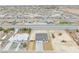 Bird's-eye view of the neighborhood showcases a modern home under construction with construction vehicles on site at 6360 Montclair St, Pahrump, NV 89061