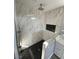 Modern bathroom featuring a glass-enclosed shower with marble tile walls and a black honeycomb floor at 6360 Montclair St, Pahrump, NV 89061