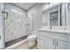 Modern bathroom featuring a walk-in shower with marble tiling and a white vanity with a marble countertop at 6360 Montclair St, Pahrump, NV 89061