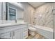 Bathroom with modern tile, large vanity, and combined tub and shower at 6360 Montclair St, Pahrump, NV 89061