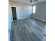 Well-lit bedroom featuring light gray walls, a ceiling fan, and wood-look flooring at 6360 Montclair St, Pahrump, NV 89061